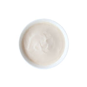 Textura cremosa del puré de pollo y pescado ahumado Kit Cat Purr Puree servida en un plato blanco
